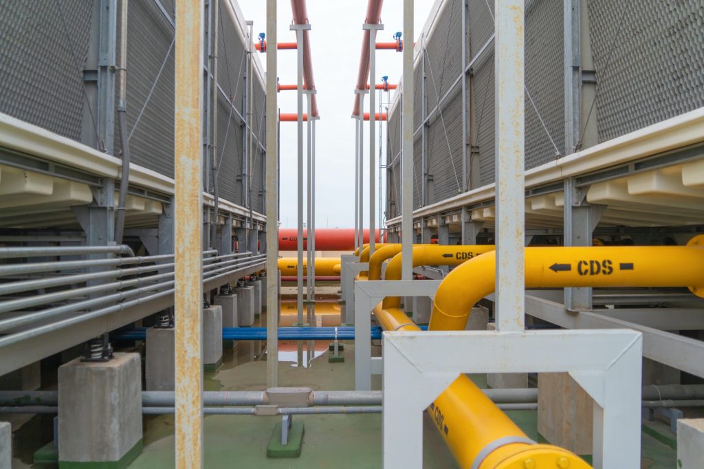 Industry factory. Cooling tower in building. System work machine. Water Supply and return pipe lines